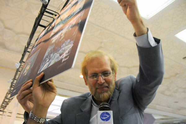 دکتر علی رامین درحال نصب نمودن تابلوی عکس در نمایشگاه مطبوعات